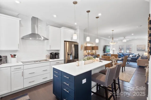 a large kitchen with a table and chairs