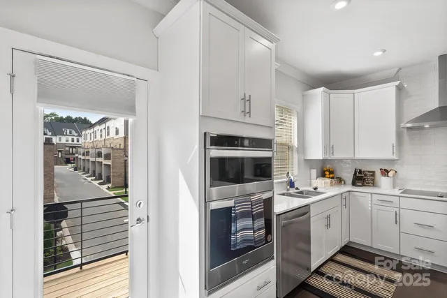 a kitchen with a sink stove top oven and cabinets