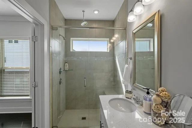a bathroom with a tub shower and sink