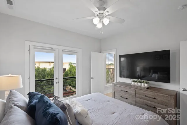 a bedroom with a bed and a flat screen tv