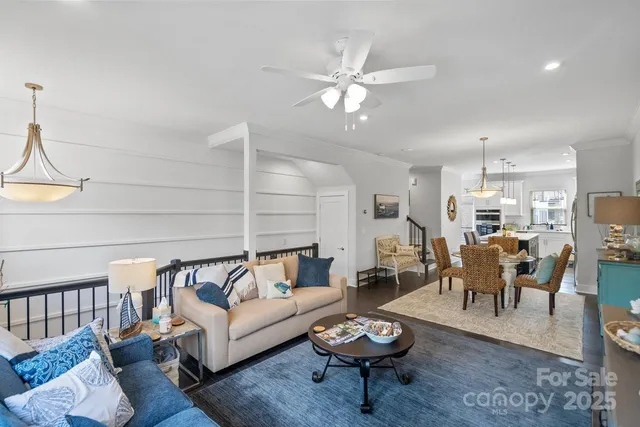 a living room with furniture a rug and a chandelier