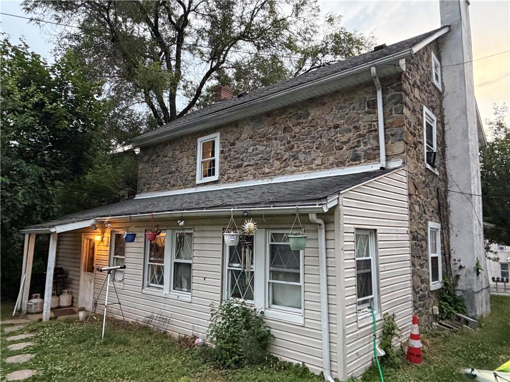 5984 Main Street Center Valley, PA 18034 - Photo 2 of 7 A classic stone facade blends with vinyl siding on this welcoming home, featuring an inviting covered entry.