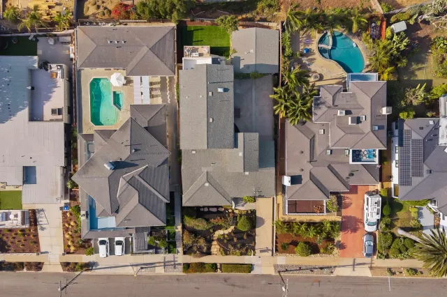 an aerial view of residential houses with street