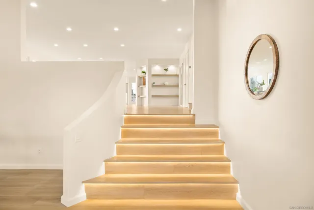 a dining room with furniture and a floor to ceiling window