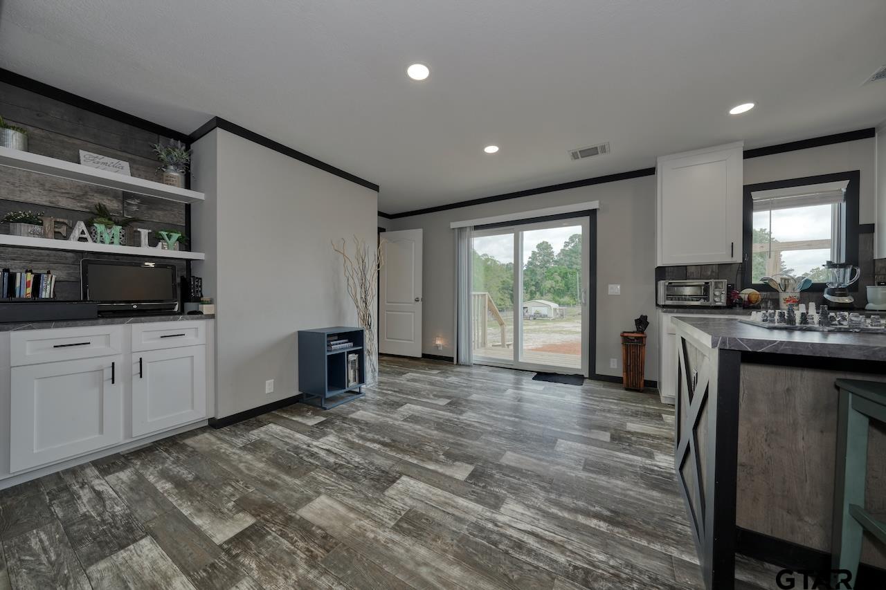 17675 Pine Drive Lindale, TX 75771 - Photo 12 of 35 a kitchen with stainless steel appliances granite countertop a stove a sink and a refrigerator