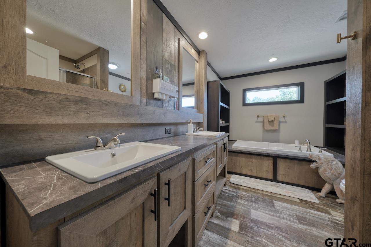 17675 Pine Drive Lindale, TX 75771 - Photo 19 of 35 a bathroom with a sink and a mirror