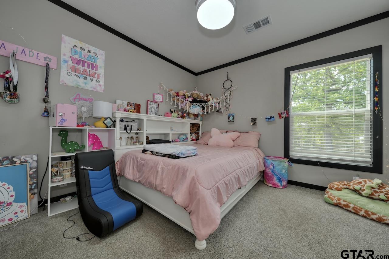 17675 Pine Drive Lindale, TX 75771 - Photo 22 of 35 a bedroom with a bed and a window