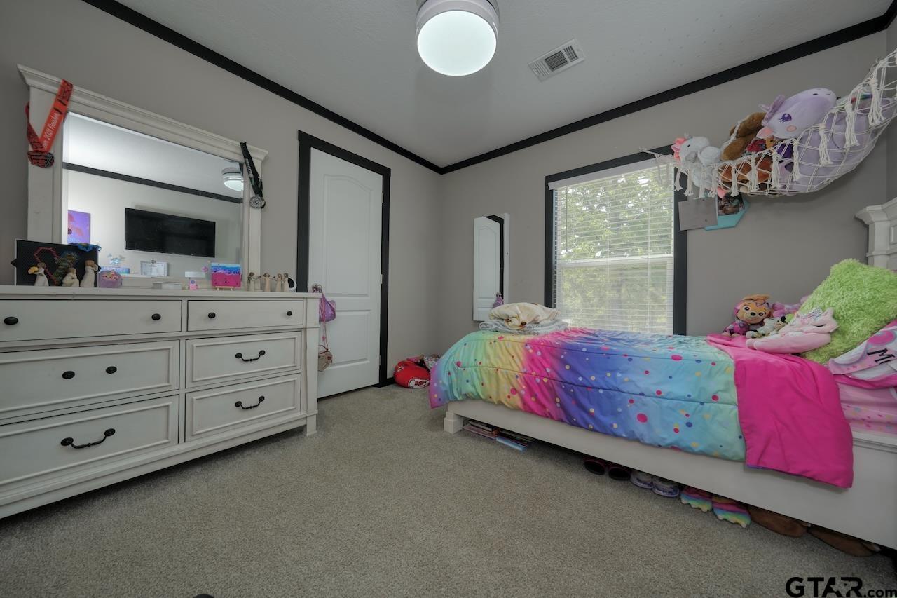 17675 Pine Drive Lindale, TX 75771 - Photo 25 of 35 a bedroom with a bed and a dresser
