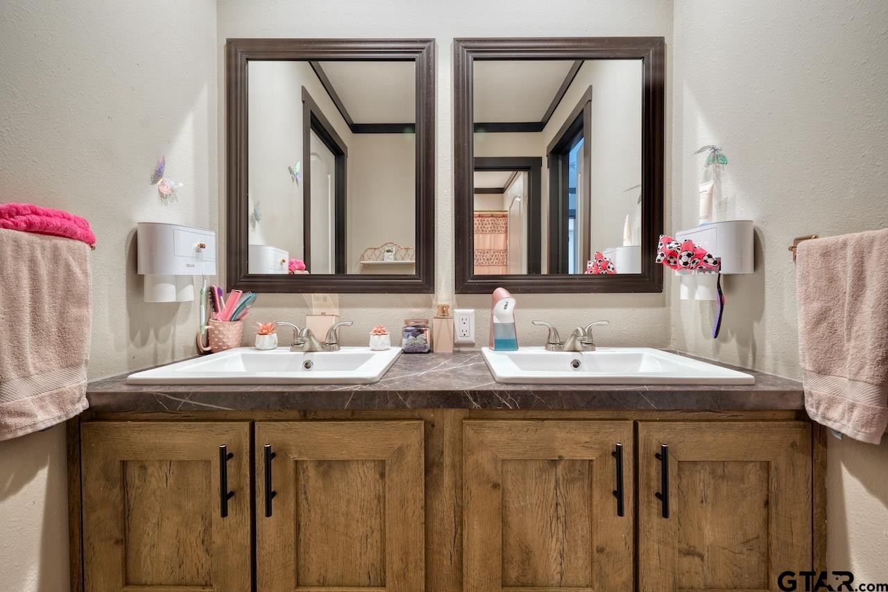 17675 Pine Drive Lindale, TX 75771 - Photo 26 of 35 a bathroom with a sink and a mirror