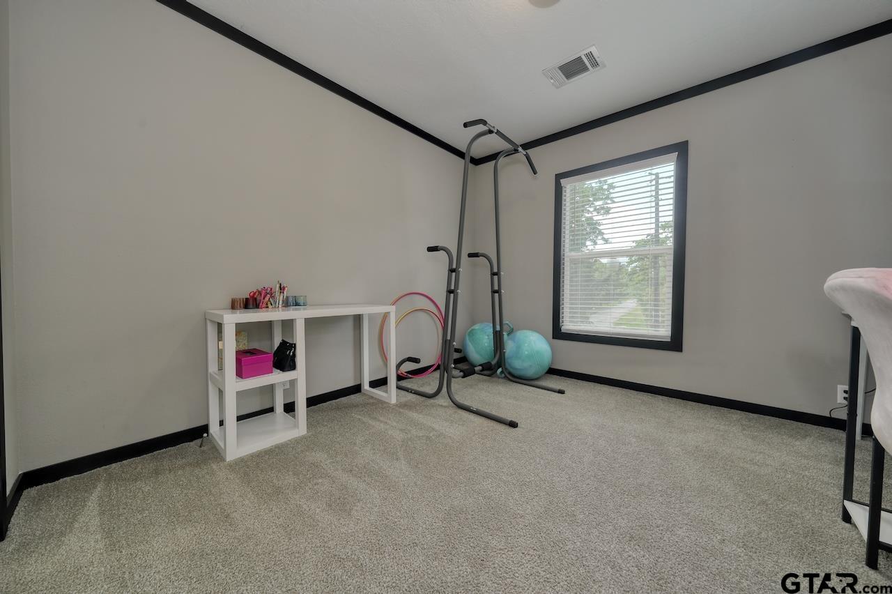 17675 Pine Drive Lindale, TX 75771 - Photo 29 of 35 a view of a room with gym equipment and a large window