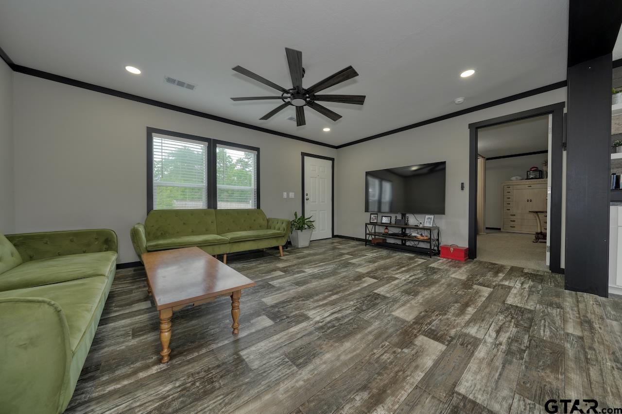 17675 Pine Drive Lindale, TX 75771 - Photo 10 of 35 a living room with furniture and a flat screen tv