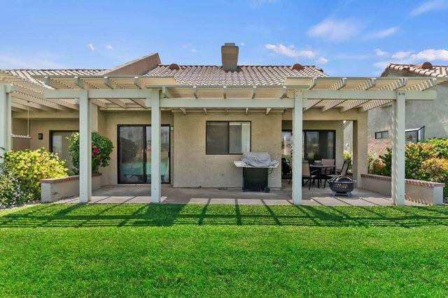 a view of a house with a yard and plants
