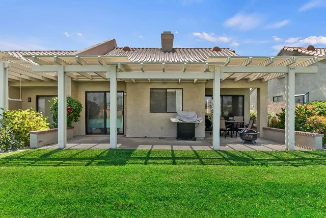 a view of a house with a yard and plants