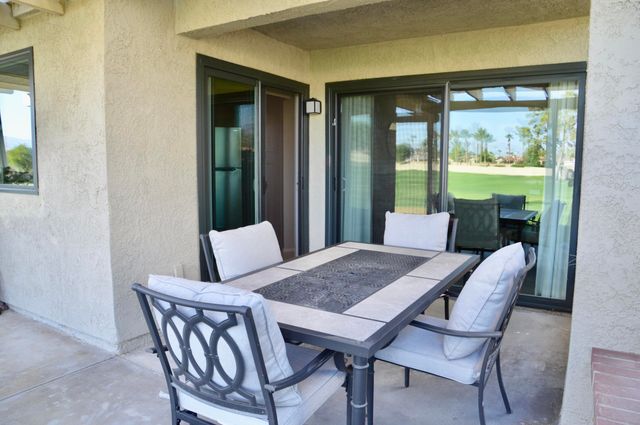 a view of a dining room with furniture large windows and wooden floor