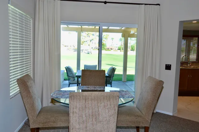 a view of a dining room with furniture window and outside view