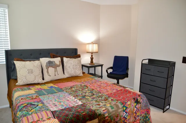 a bedroom with a bed and two lamp