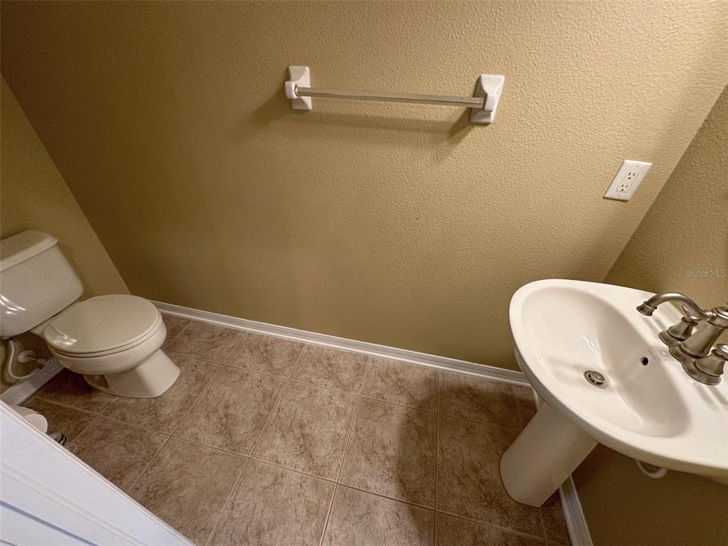 11801 Essington Street New Port Richey, FL 34654 - Photo 18 of 79 a bathroom with a toilet sink and mirror