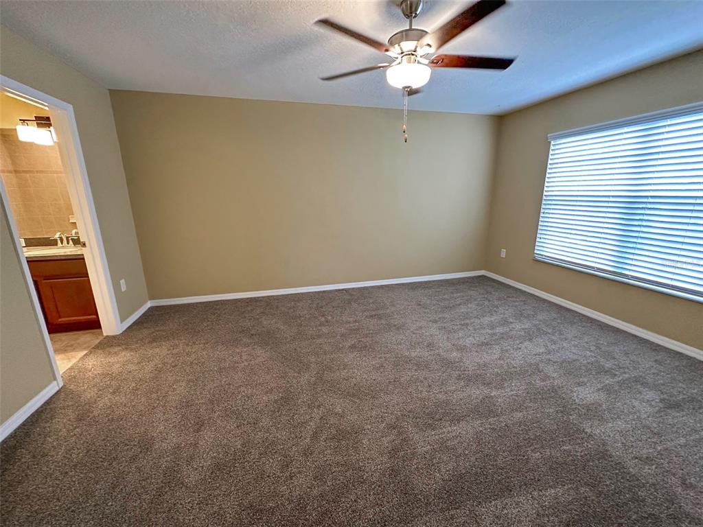 11801 Essington Street New Port Richey, FL 34654 - Photo 26 of 79 an empty room with a window and a fan