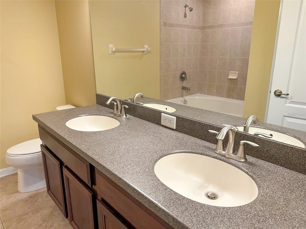 11801 Essington Street New Port Richey, FL 34654 - Photo 29 of 79 a bathroom with a granite countertop sink and a mirror