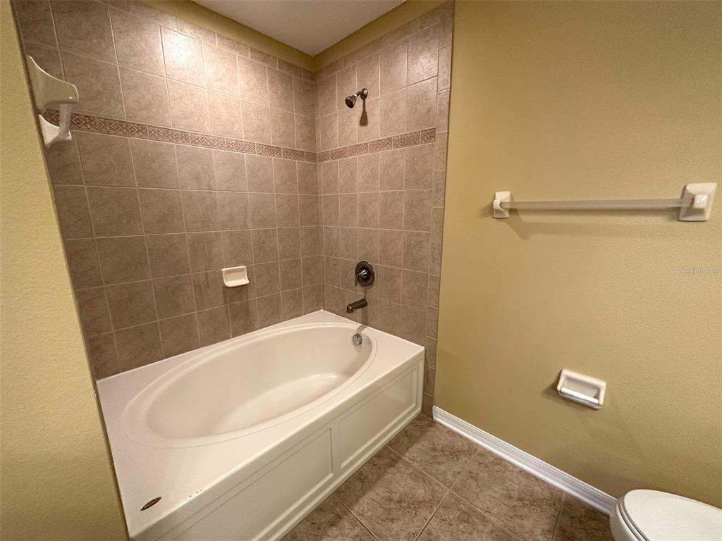 11801 Essington Street New Port Richey, FL 34654 - Photo 31 of 79 a bathroom with a white bath tub and a shower