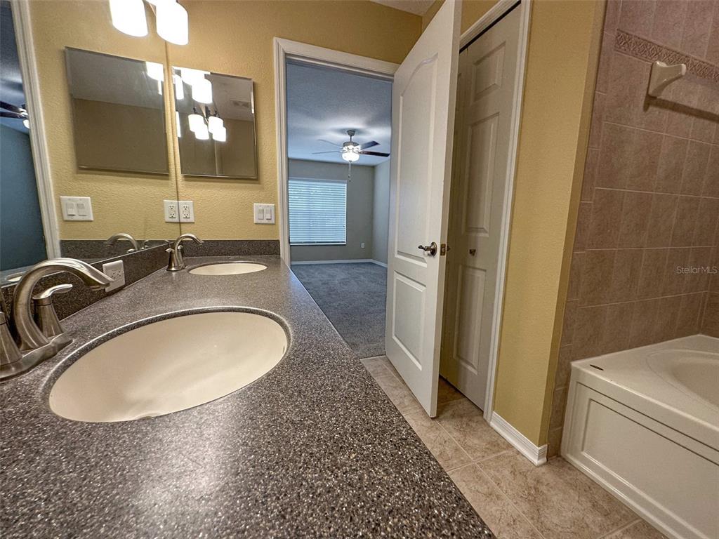 11801 Essington Street New Port Richey, FL 34654 - Photo 33 of 79 a bathroom with a sink a toilet and a mirror