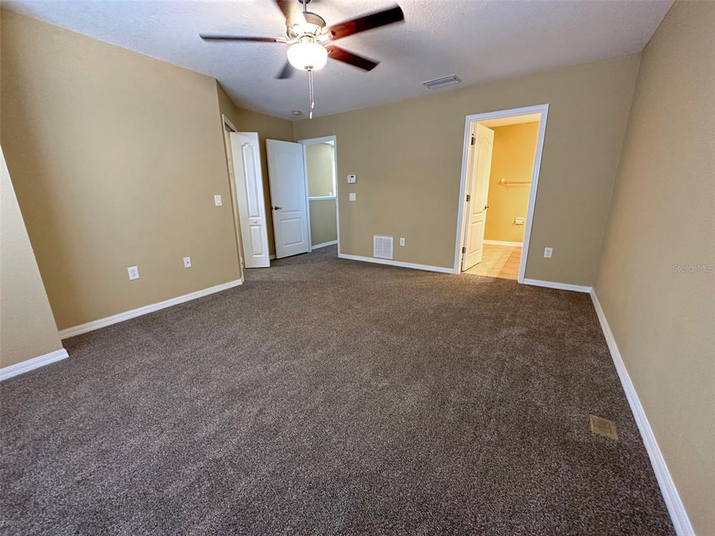 11801 Essington Street New Port Richey, FL 34654 - Photo 35 of 79 an empty room with a ceiling fan and a window