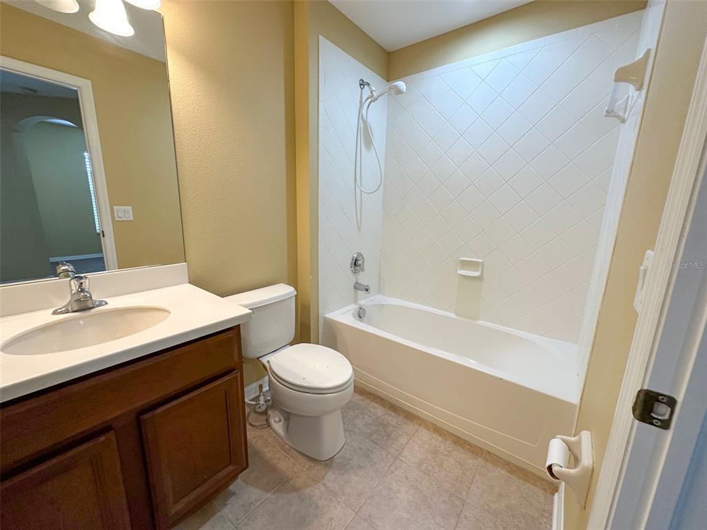 11801 Essington Street New Port Richey, FL 34654 - Photo 45 of 79 a bathroom with a sink a toilet and shower