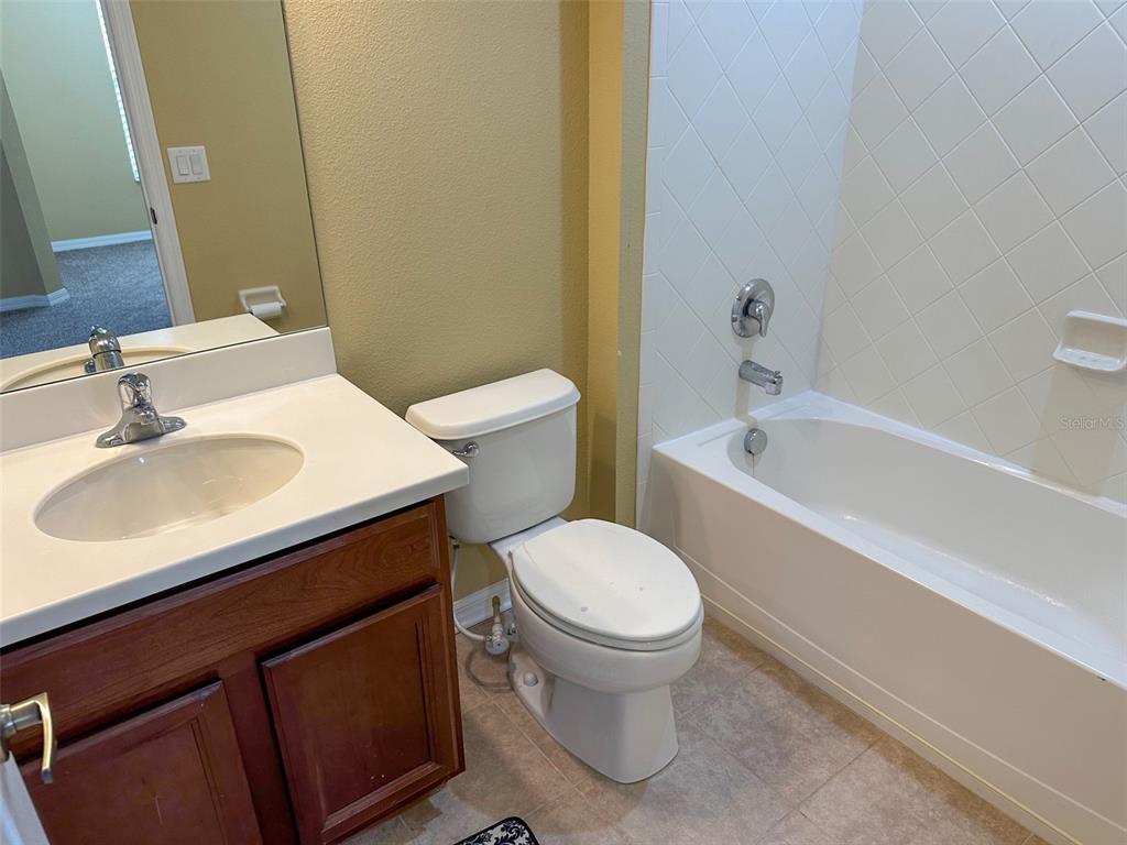 11801 Essington Street New Port Richey, FL 34654 - Photo 47 of 79 a white toilet sitting next to a bathroom sink