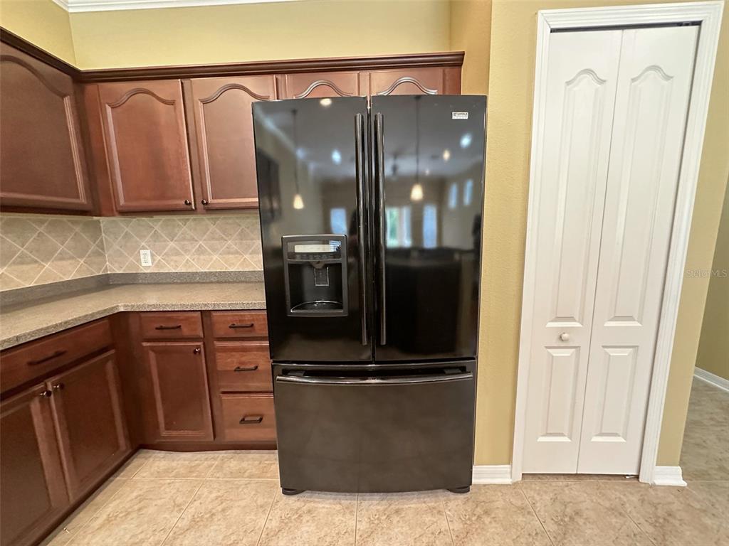 11801 Essington Street New Port Richey, FL 34654 - Photo 7 of 79 a kitchen with granite countertop a refrigerator and a sink