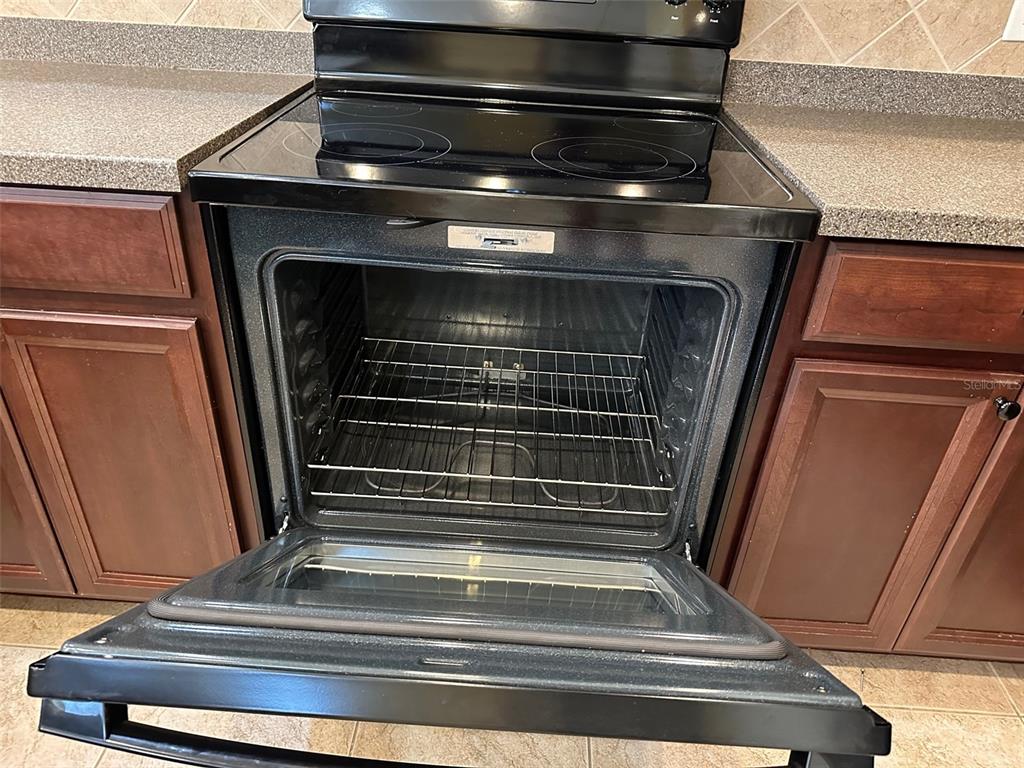 11801 Essington Street New Port Richey, FL 34654 - Photo 10 of 79 a stove top oven sitting inside of a kitchen