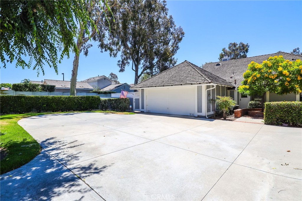 a front view of a house with a yard and trees