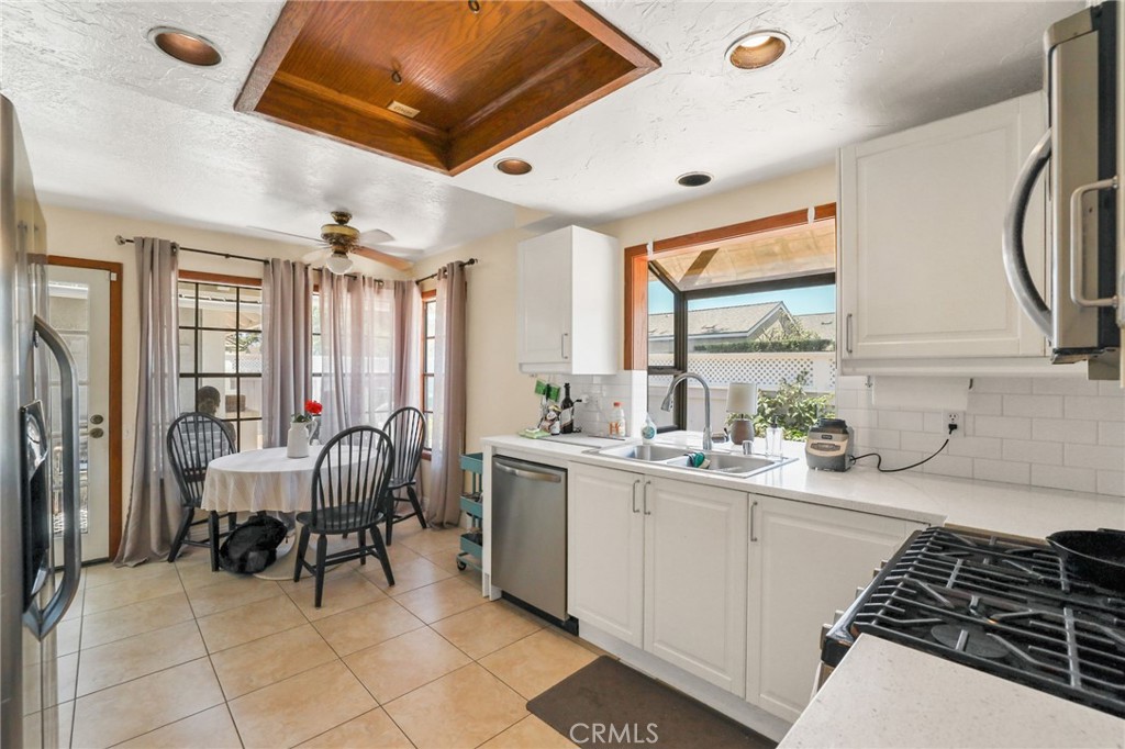 14 Thunder Trail, Unit 28 Irvine, CA 92614 - Photo 12 of 60 The remodeled kitchen with garden window, Quartz countertop, with all stainless steel appliances. The breakfast nook is bright with windows, and a door leading to the backyard and the garage.