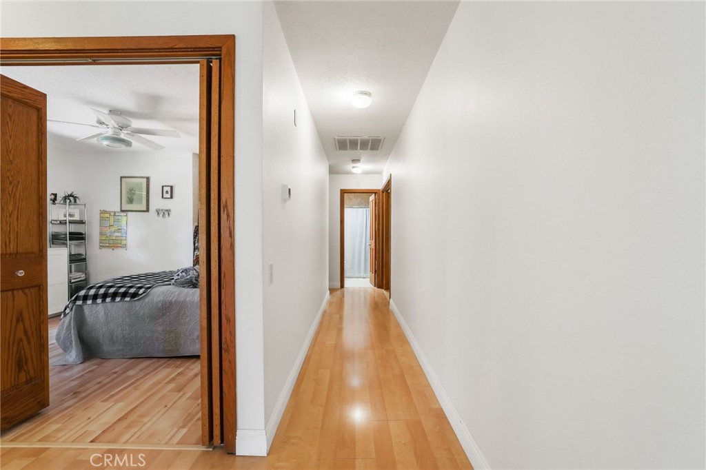 14 Thunder Trail, Unit 28 Irvine, CA 92614 - Photo 20 of 60 a view of a hallway with wooden floor and a living room