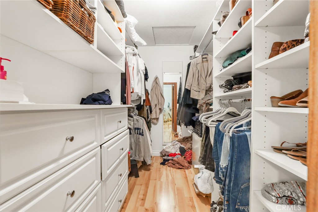 14 Thunder Trail, Unit 28 Irvine, CA 92614 - Photo 28 of 60 a view of walk in closet with clothes and shoes