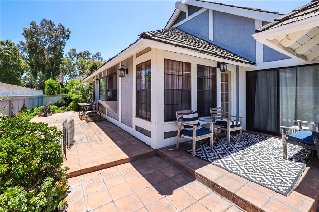 14 Thunder Trail, Unit 28 Irvine, CA 92614 - Photo 29 of 60 a view of a patio with table and chairs with wooden floor and fence