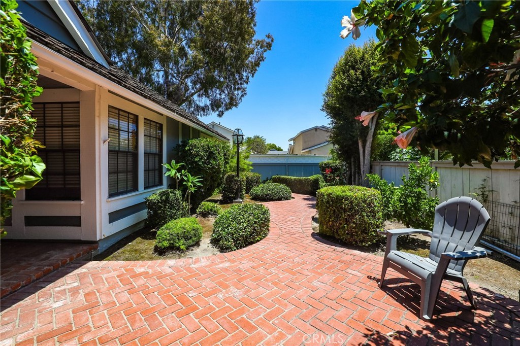 14 Thunder Trail, Unit 28 Irvine, CA 92614 - Photo 4 of 60 a view of a chair and tables in the backyard of the house