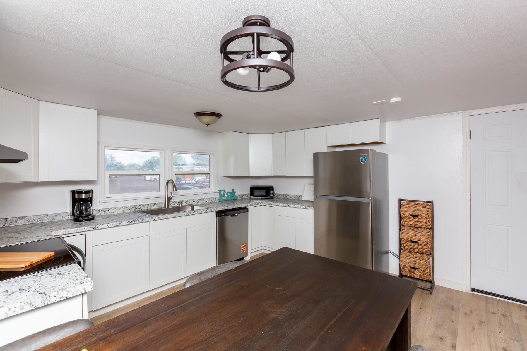424 32 Road, Unit 112 Clifton, CO 81520 - Photo 11 of 41 a kitchen with a refrigerator a stove a sink and a wooden floors