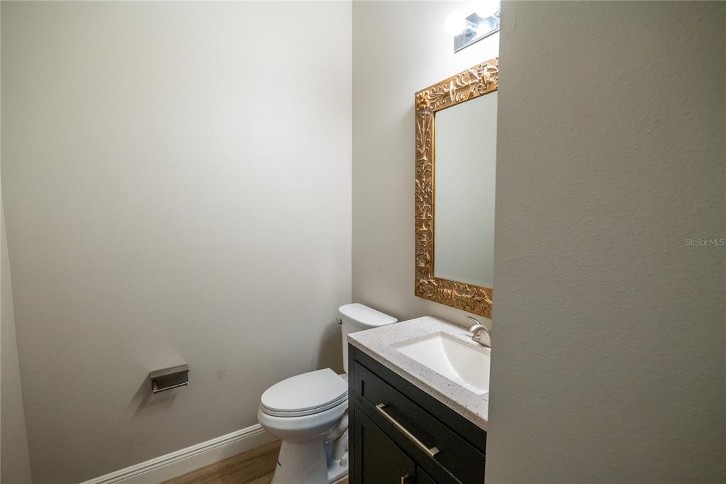 852 North Jacks Lake Road Clermont, FL 34711 - Photo 14 of 29 a bathroom with a granite countertop toilet and sink
