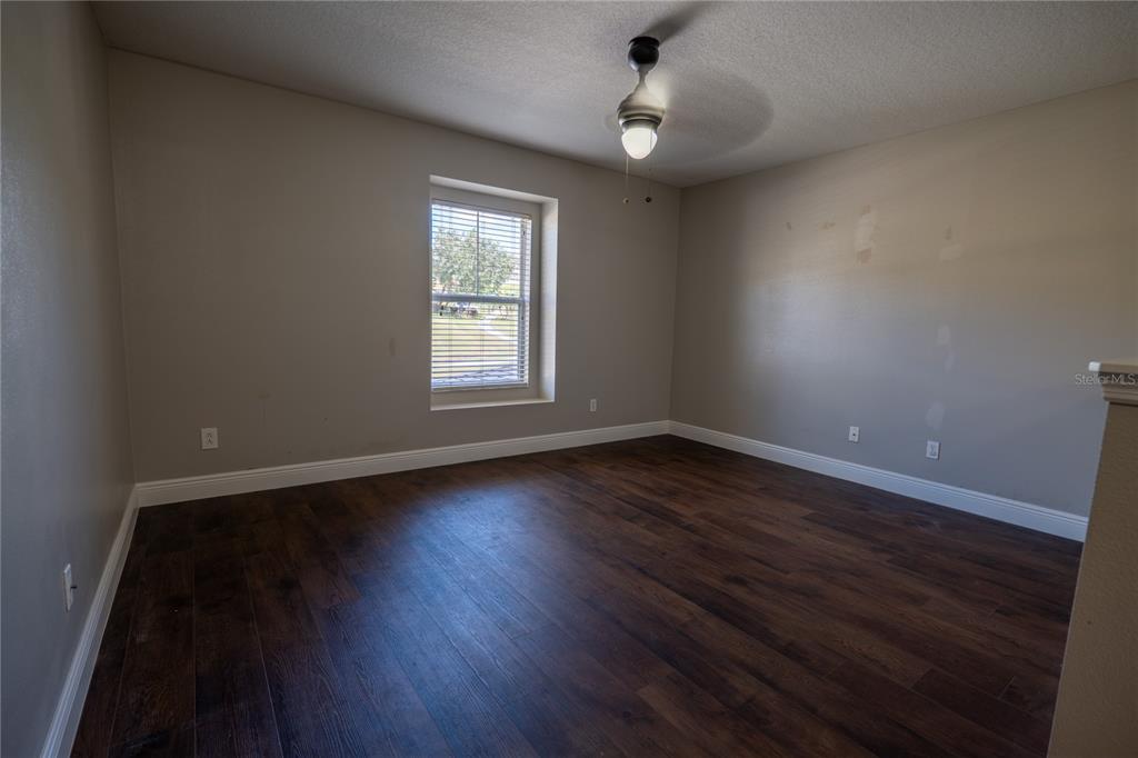 852 North Jacks Lake Road Clermont, FL 34711 - Photo 15 of 29 an empty room with wooden floor and windows