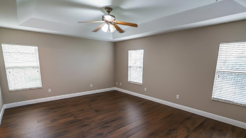 852 North Jacks Lake Road Clermont, FL 34711 - Photo 17 of 29 a view of an empty room with wooden floor and a window