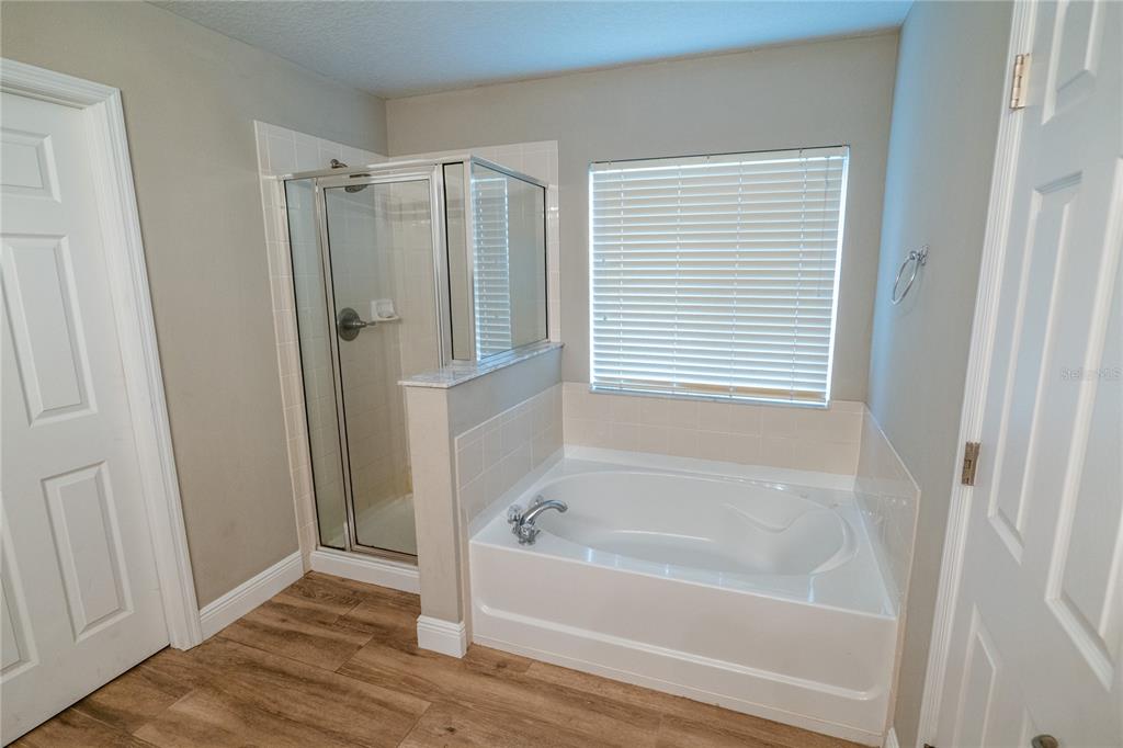 852 North Jacks Lake Road Clermont, FL 34711 - Photo 19 of 29 a bathroom with bathtub and a shower