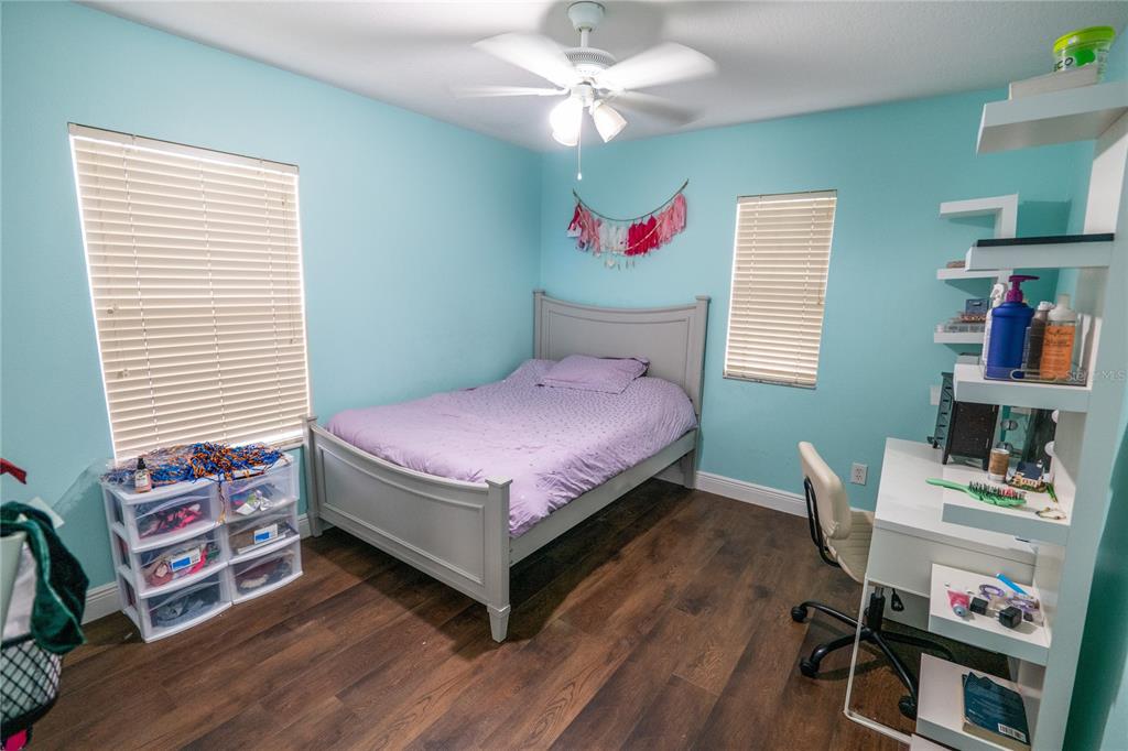 852 North Jacks Lake Road Clermont, FL 34711 - Photo 21 of 29 a bedroom with a bed and a bookshelf