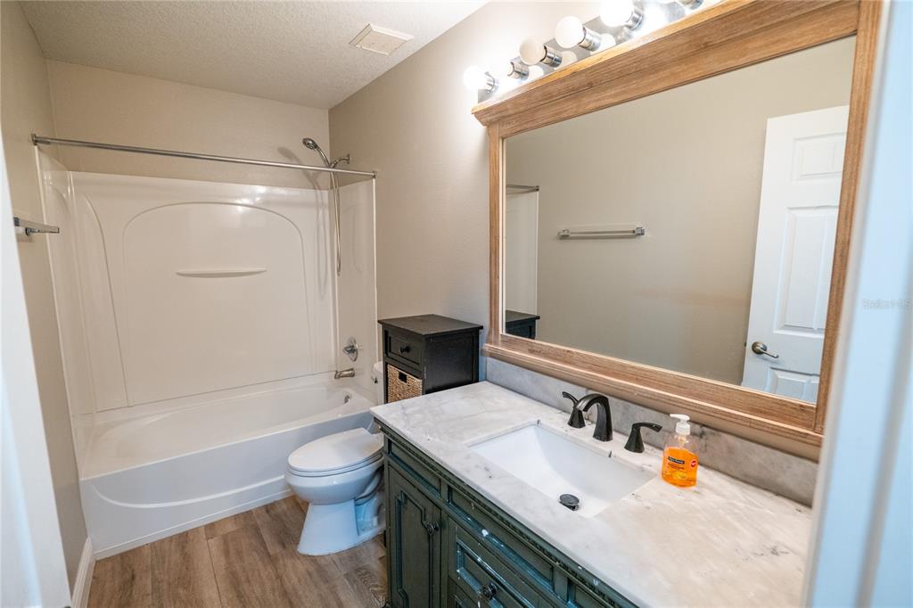 852 North Jacks Lake Road Clermont, FL 34711 - Photo 22 of 29 a bathroom with a sink toilet and shower