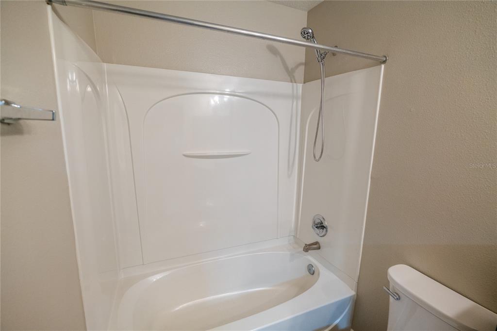 852 North Jacks Lake Road Clermont, FL 34711 - Photo 23 of 29 a bathroom with a bathtub and a shower