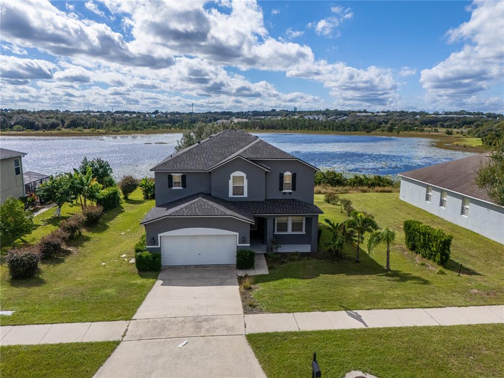 852 North Jacks Lake Road Clermont, FL 34711 - Photo 28 of 29 a front view of a house with a garden and lake view