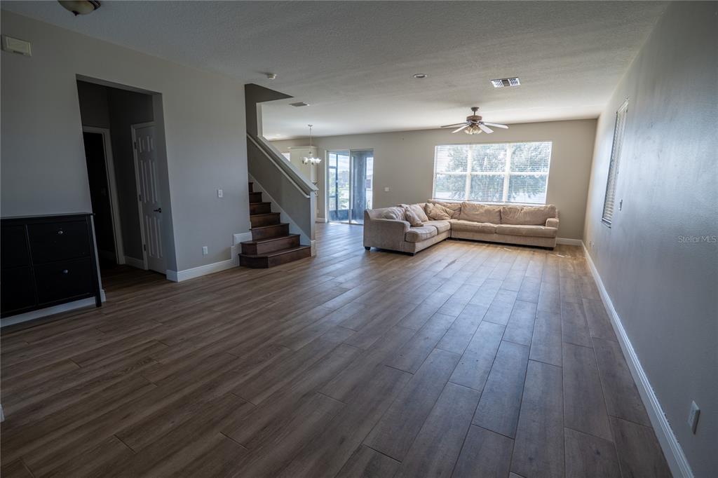852 North Jacks Lake Road Clermont, FL 34711 - Photo 5 of 29 a view of a livingroom with hardwood floor and a ceiling fan