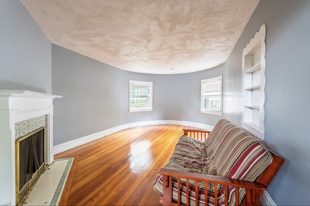 85 Naples Road Brookline, MA 02446 - Photo 11 of 19 a view of a bedroom with furniture and a fireplace