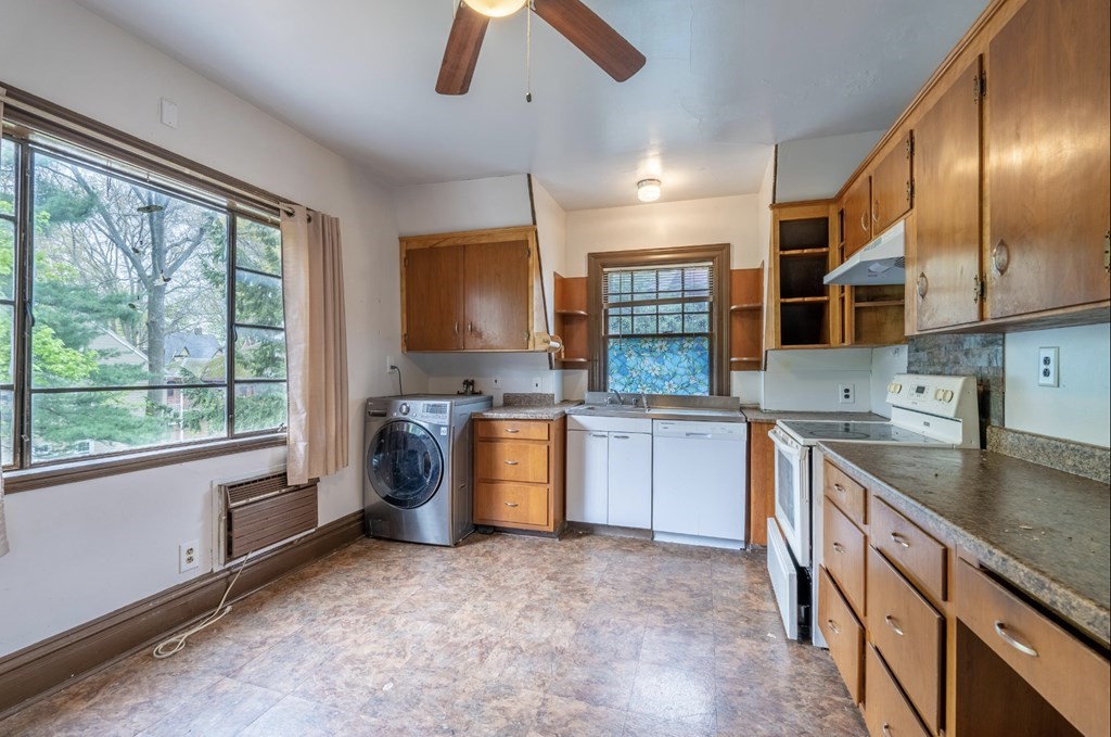 85 Naples Road Brookline, MA 02446 - Photo 13 of 19 a kitchen with stainless steel appliances granite countertop a sink a stove and a refrigerator
