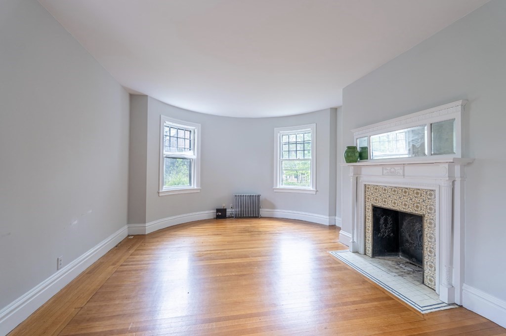85 Naples Road Brookline, MA 02446 - Photo 5 of 19 a view of an empty room with window and fire place