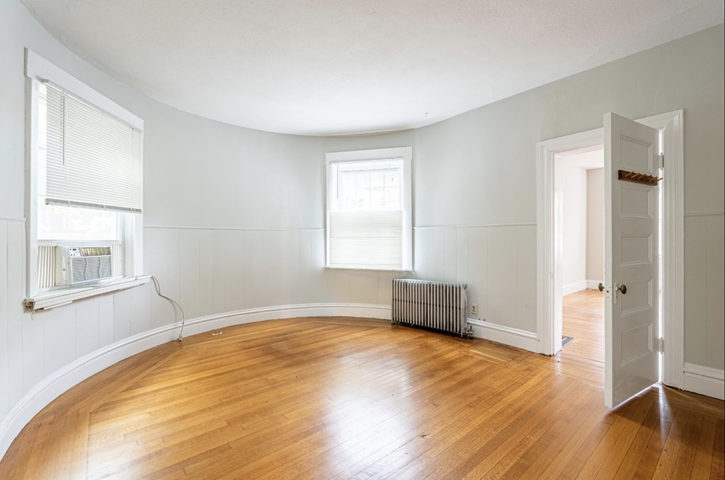 85 Naples Road Brookline, MA 02446 - Photo 7 of 19 a view of empty room with wooden floor and fan
